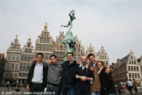 Group of friends in front of the Brabo fountain and guild houses on Antwerp's Grote Markt