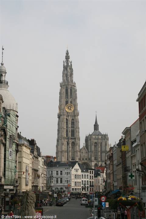 Antwerp's Cathedral of Our Lady towers over a busy street lined with houses