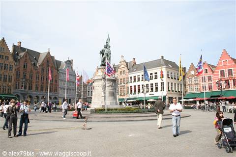 Tourists stroll around the statue on the Markt square in Bruges