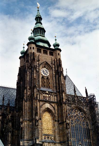 St. Vitus Cathedral in Prague, green spires and clock on the stone tower