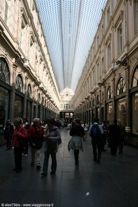 Tourists walk under the glass vault of the Galeries Royales Saint-Hubert, Brussels