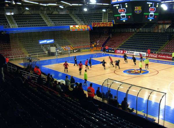 Futsal match at Palau Blaugrana, blue court with Barça logos