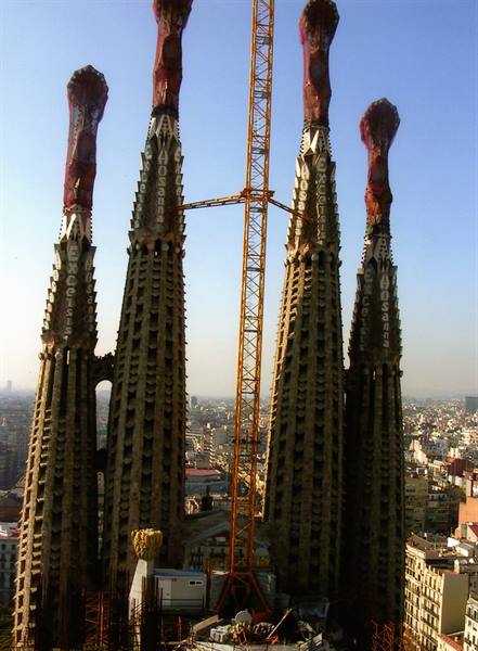 The four towers of Sagrada Família in Barcelona with the yellow crane
