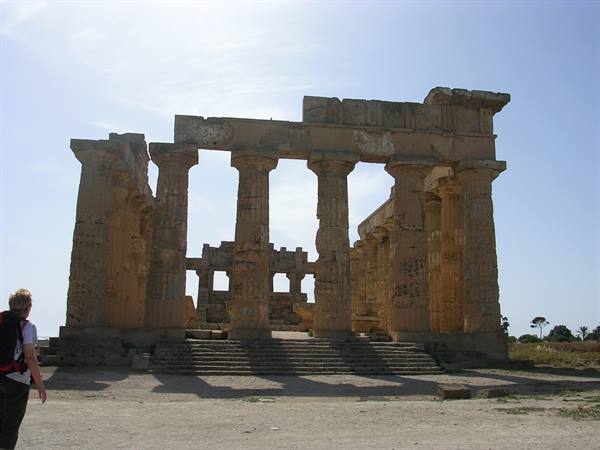 Tourist walking before the Doric temple ruins at Selinunte