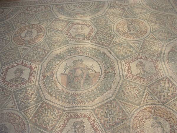 Roman floor mosaic with female figures in roundels and geometric patterns