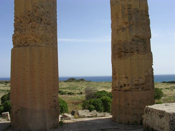 Doric sandstone columns at Selinunte, Mediterranean scrub and sea