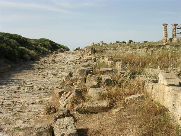 Ancient paved stone road among ruins and Doric columns at Selinunte
