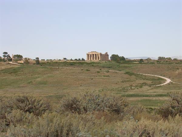 Doric stone temple on the hill, dirt path winding through dry shrubs