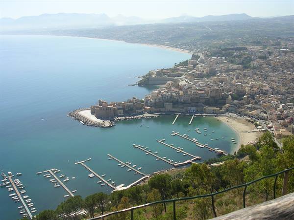 Castellammare del Golfo marina with piers, moored boats and houses facing the sea