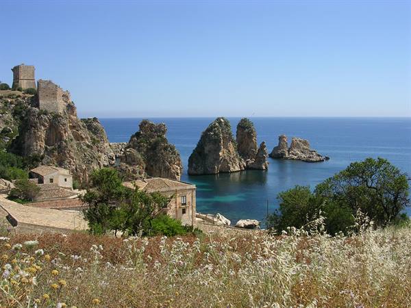 Scopello tonnara with the faraglioni rocks in the blue Sicilian sea