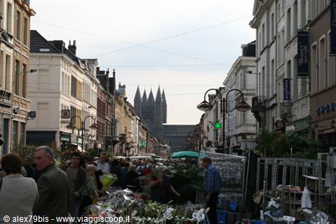 Flower market on a busy street, with the towers of Breda's Grote Kerk behind