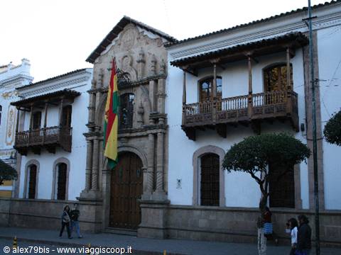 Casa de la Libertad in Sucre, stone facade with Bolivian flag and wooden balconies