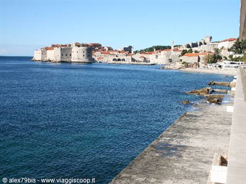 Dubrovnik walls along the shore, towers and terracotta roofs by the sea