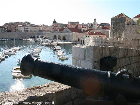 Cannon overlooking Dubrovnik old harbour, boats and stone city walls