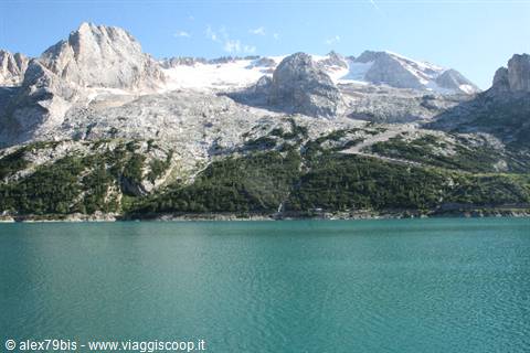 Fedaia Lake with turquoise water beneath Marmolada and its glacier