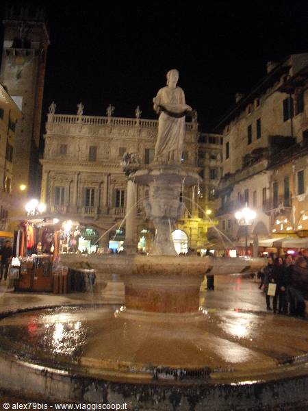The Madonna Verona fountain lights up Piazza delle Erbe at night, Palazzo Maffei behind