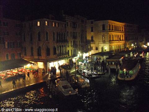 Vaporettos and gondolas moored at night along Venice's Grand Canal