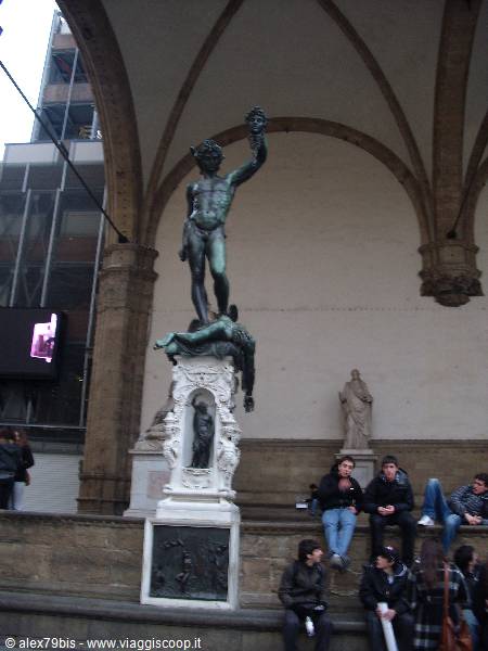 Cellini's bronze Perseus holding Medusa's head under Loggia dei Lanzi arches