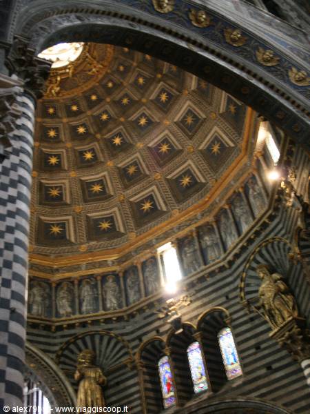 Inside Siena Cathedral, star-studded golden dome, black and white striped columns
