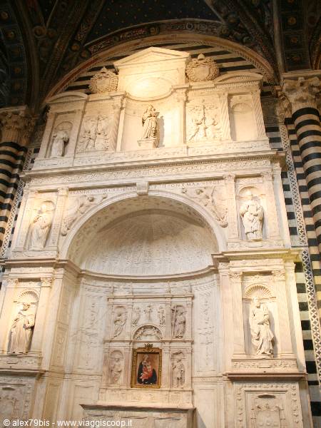 Carved marble altar with statues inside Siena Cathedral