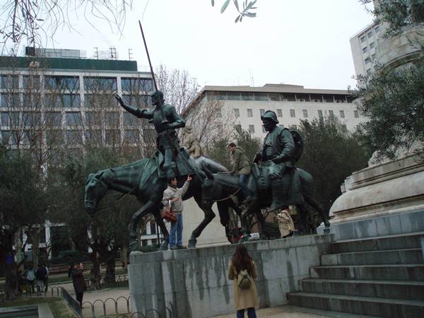 Bronze statues of Don Quixote and Sancho Panza, tourists beside the horses
