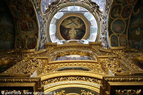 Golden iconostasis and painted dome inside the Orthodox church of Kyiv Pechersk Lavra