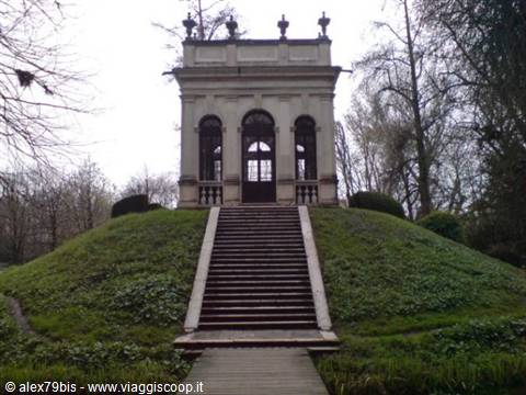 Stone staircase climbing the green hill toward a small neoclassical pavilion