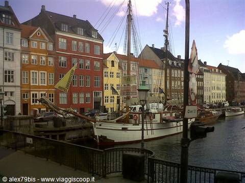 Historic ship moored at Nyhavn, colorful facades along Copenhagen's canal