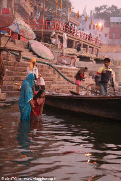 Women in saris bathe in the Ganges beneath the ghats of Varanasi