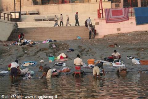 Washermen scrubbing clothes in the Ganges river at Varanasi ghats