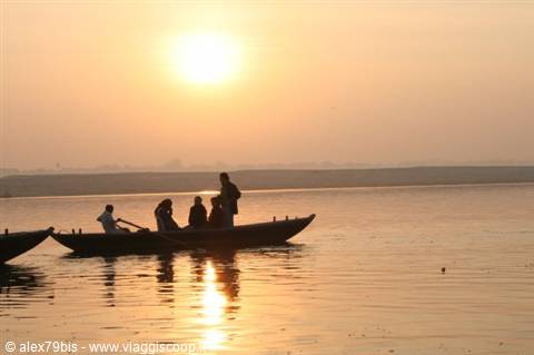 Boat with passengers on the Ganges in Varanasi in golden morning light