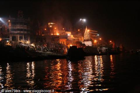 Varanasi: flames and ghat lights reflect on the dark Ganges at night