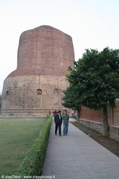 Tourists walk along the path beneath the Dhamek Stupa in Sarnath