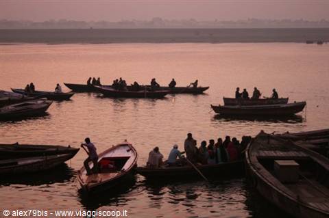 Wooden boats carrying passengers on the Ganges river in Varanasi at dawn