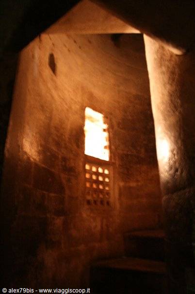 Stone stairway with golden light through carved stone lattice