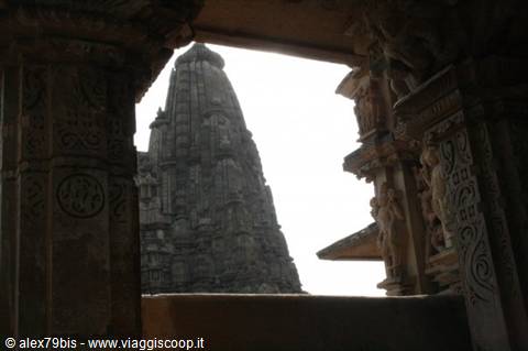 Khajuraho temple framed by intricately carved stone pillars