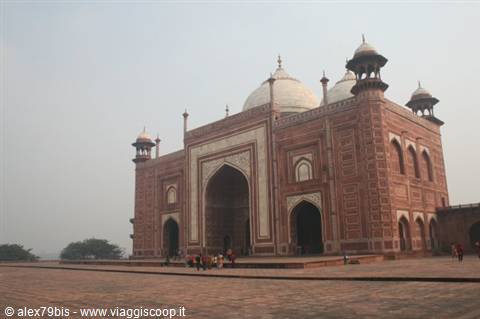 Red brick mosque of the Taj Mahal under morning haze