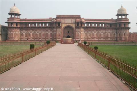 Agra Fort: red sandstone facade, paved walkway between lawns and iron fences