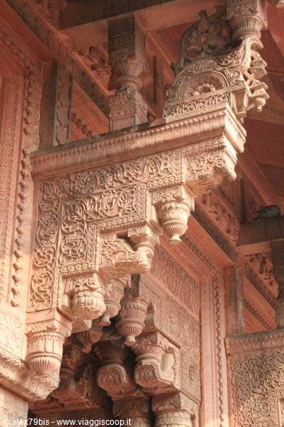 carved sandstone brackets with floral motifs, intricate architectural ornament