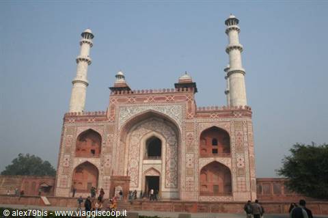 Akbar's Tomb at Sikandra, red sandstone facade with white minarets and visitors