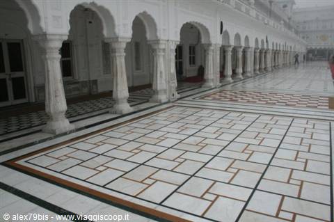 White marble colonnade with arches and geometric tiled floor, Golden Temple, Amritsar