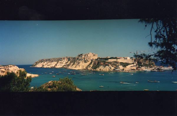 Tremiti Islands: boats in the bay beneath the fortified abbey of San Nicola