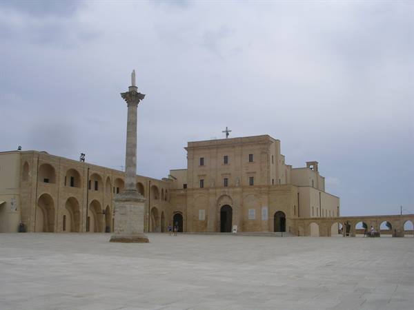 Column and basilica forecourt at Santa Maria di Leuca under grey sky