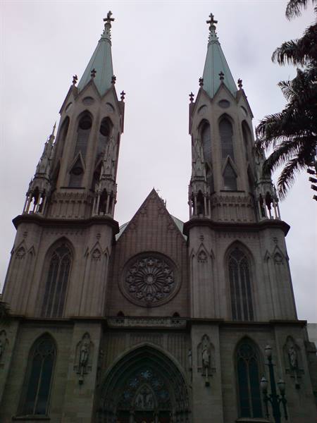 Granite Gothic facade of Petrópolis Cathedral with two spires under a gray sky