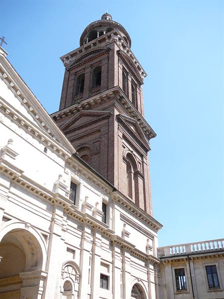 Brick bell tower of San Geremia church in Venice against a blue sky