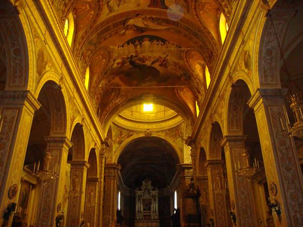 Baroque church nave with golden frescoed vault and warm light
