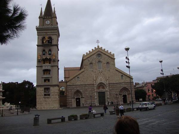 Messina Cathedral with its astronomical bell tower under a grey sky