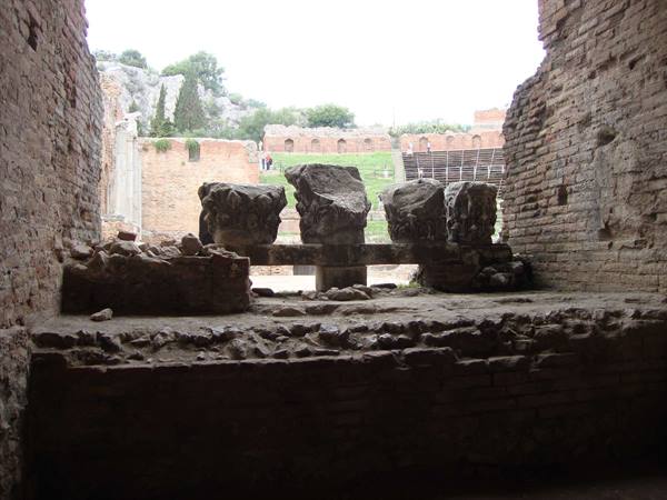 Stone capitals on brick wall, ancient Greek theatre of Taormina