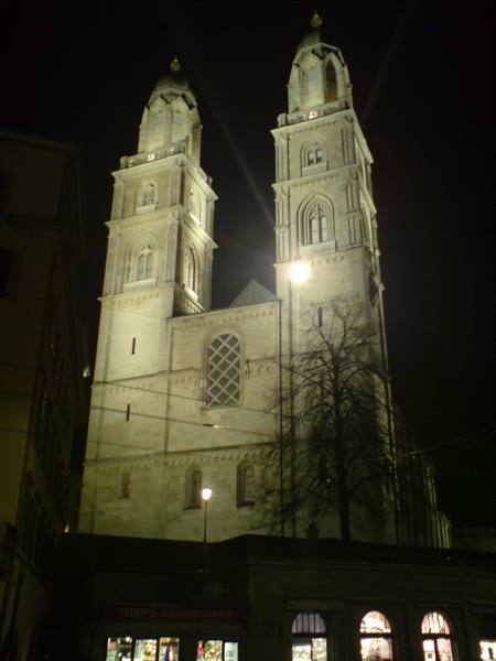 Zurich Grossmünster at night, twin stone towers lit up