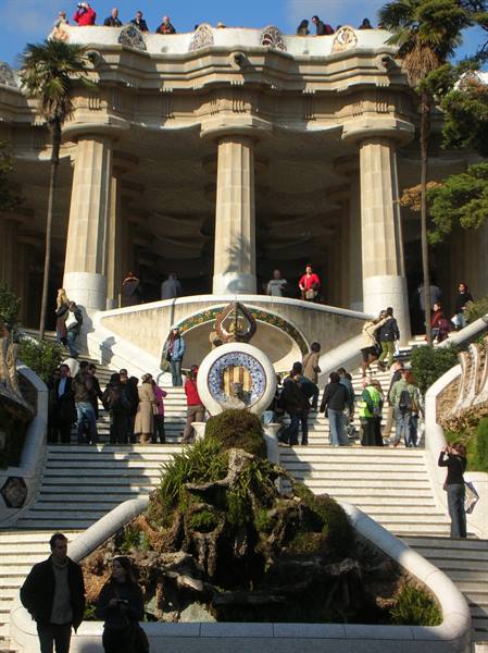 Tourists on the stairs and stone colonnade of Gaudí's Park Güell, Barcelona